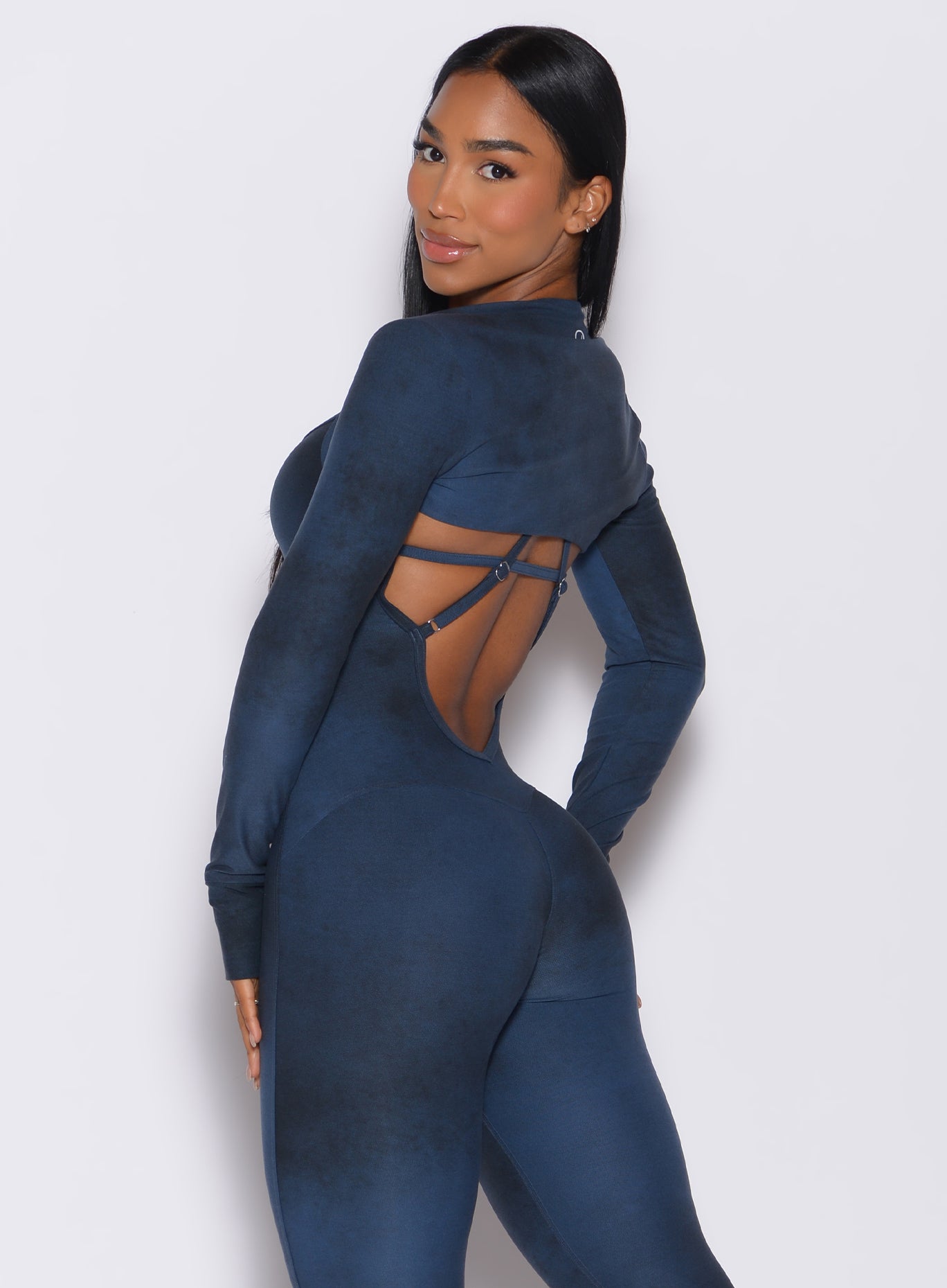 Left side profile view of a model wearing our shape shrug in vintage blue color along with the matching full length bodysuit