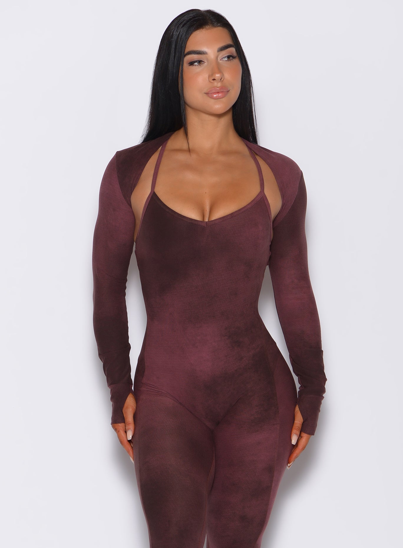 Front profile view of a model wearing our shape shrug in vintage port color along with the matching full length bodysuit