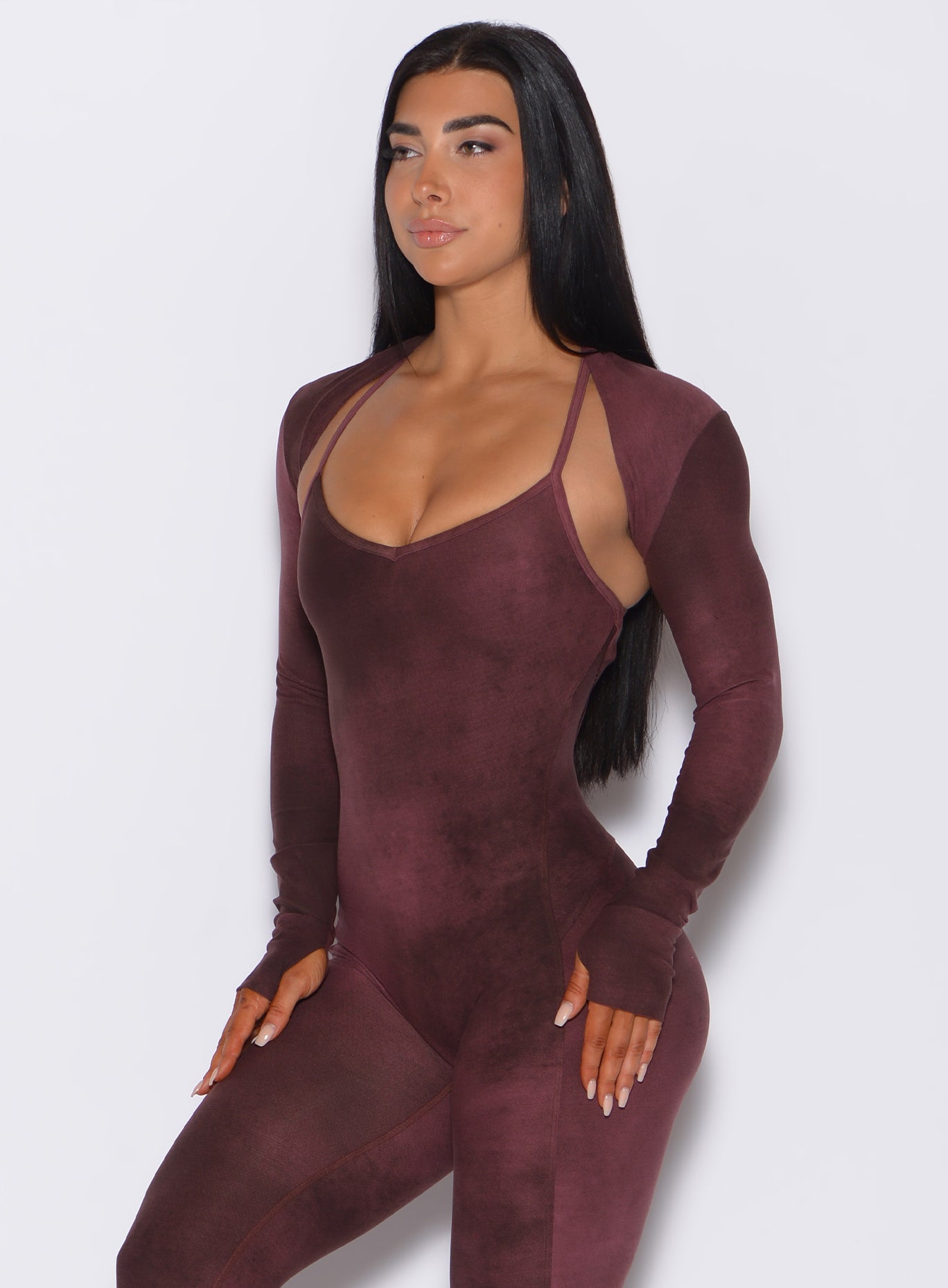 Front profile view of a model wearing our shape shrug along with a bodysuit in vintage port color