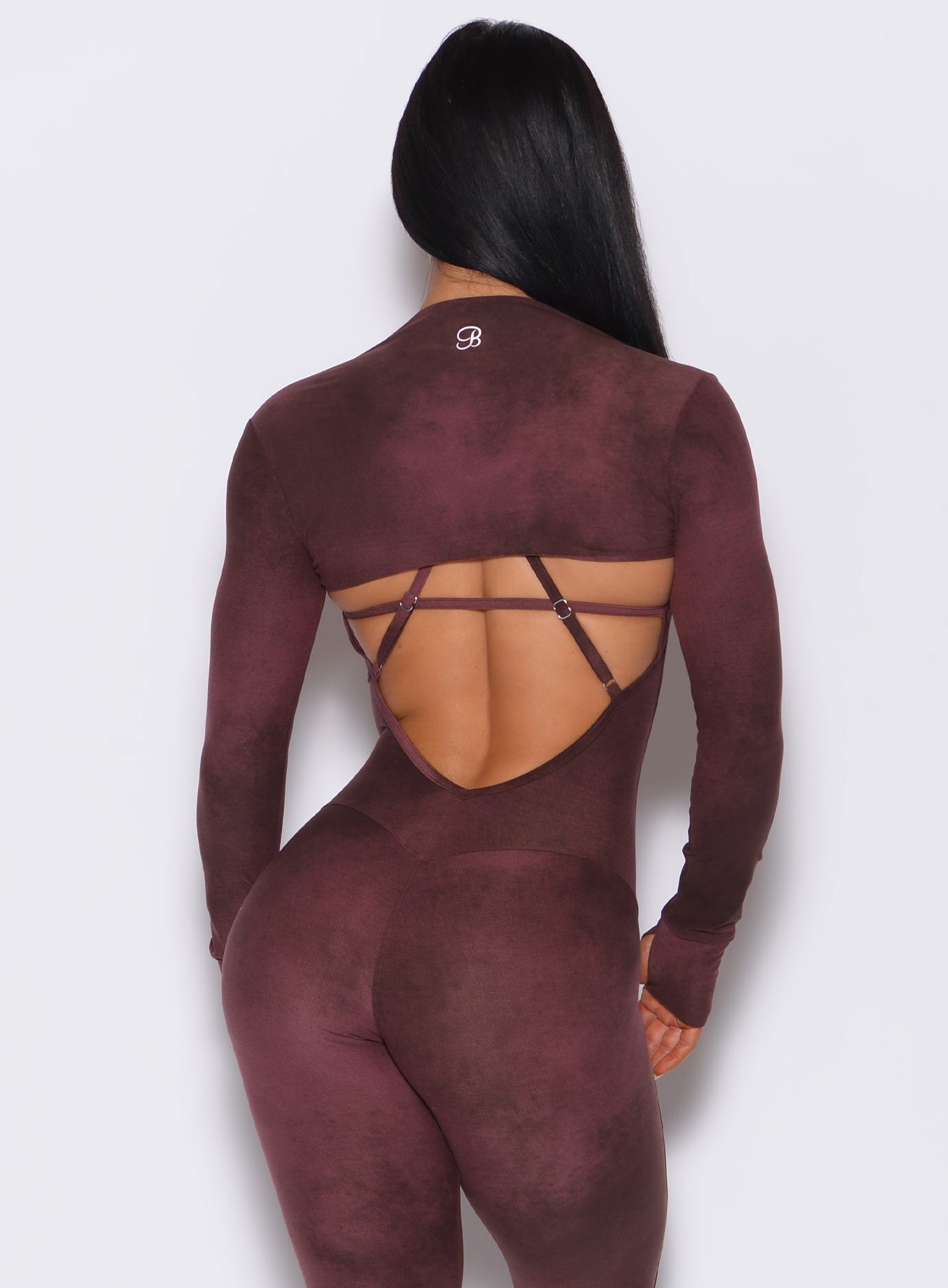 Back profile view of a model wearing our shape shrug along with a bodysuit in vintage port color