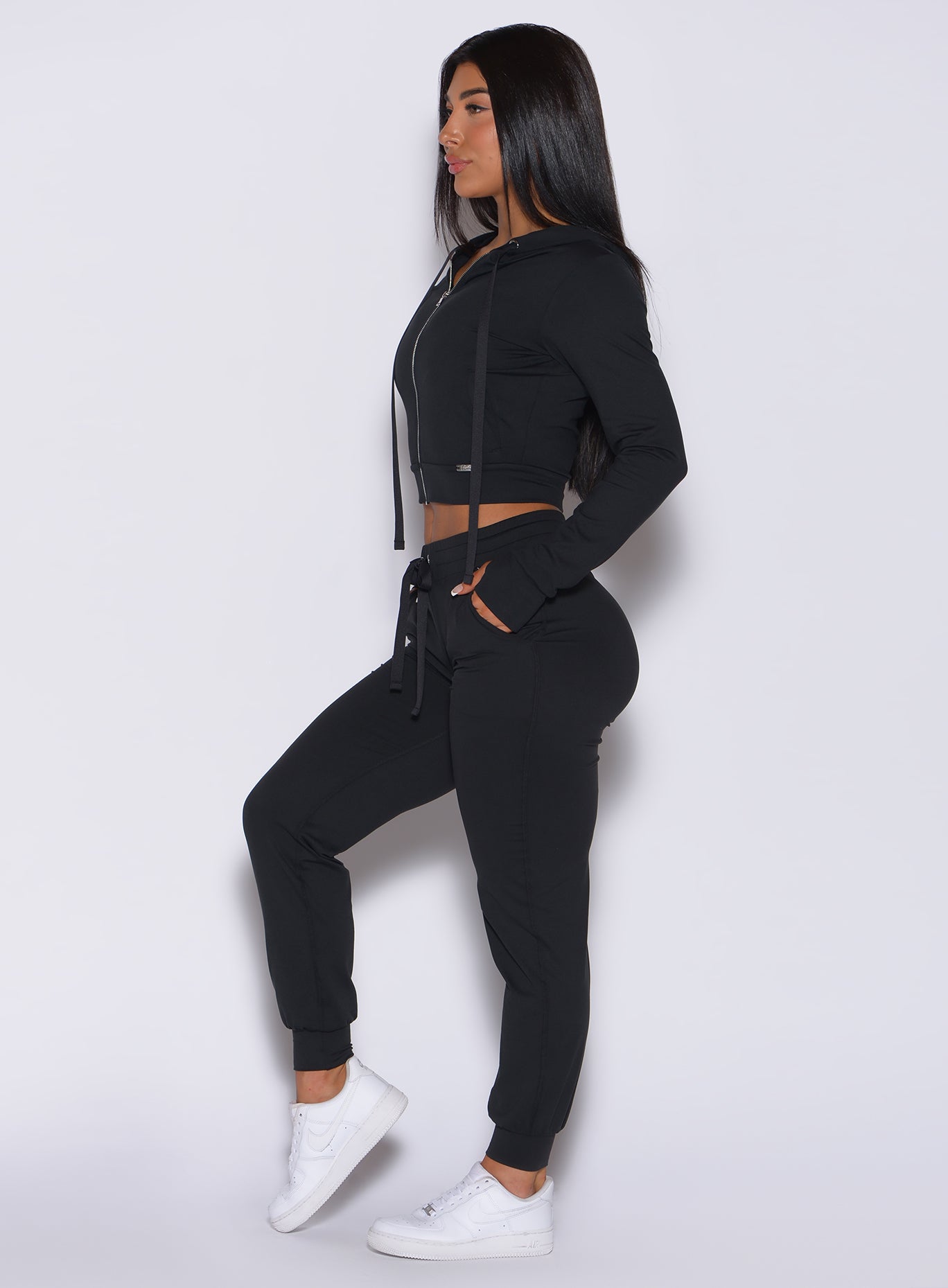 side view of model in the signature jacket in black and matching joggers