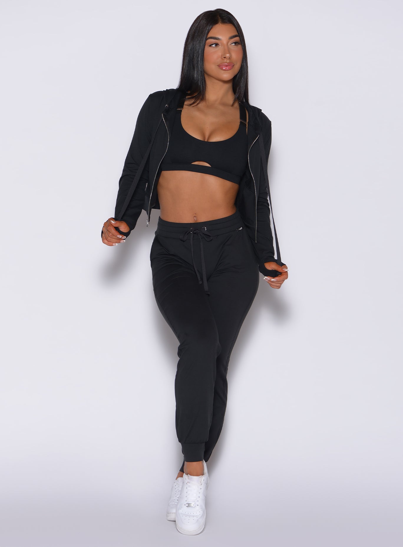 front view of model wearing bombshells black signature zip front jacket and front tie cozy joggers