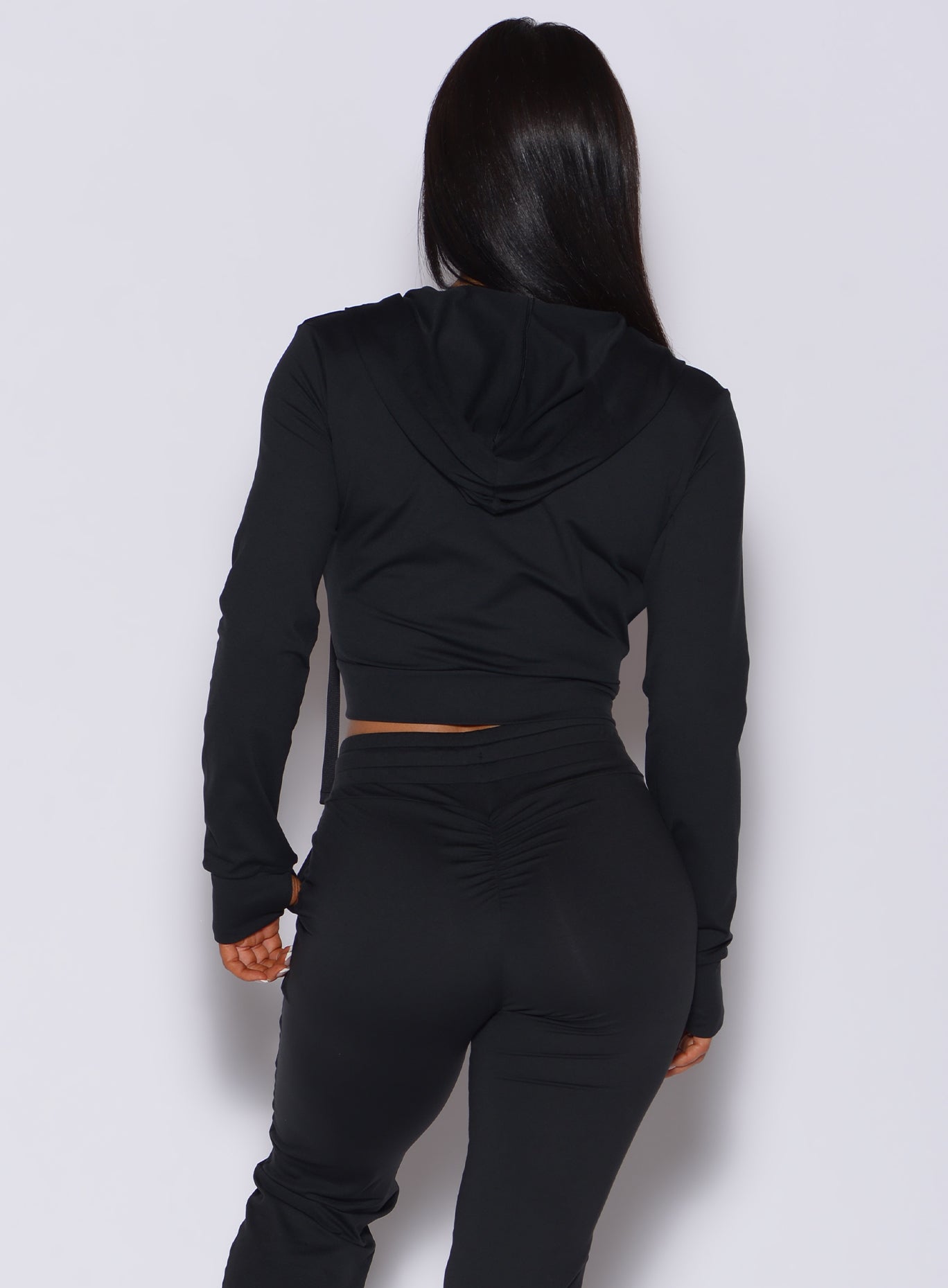 back view of model wearing the signature hoodie jacket in black