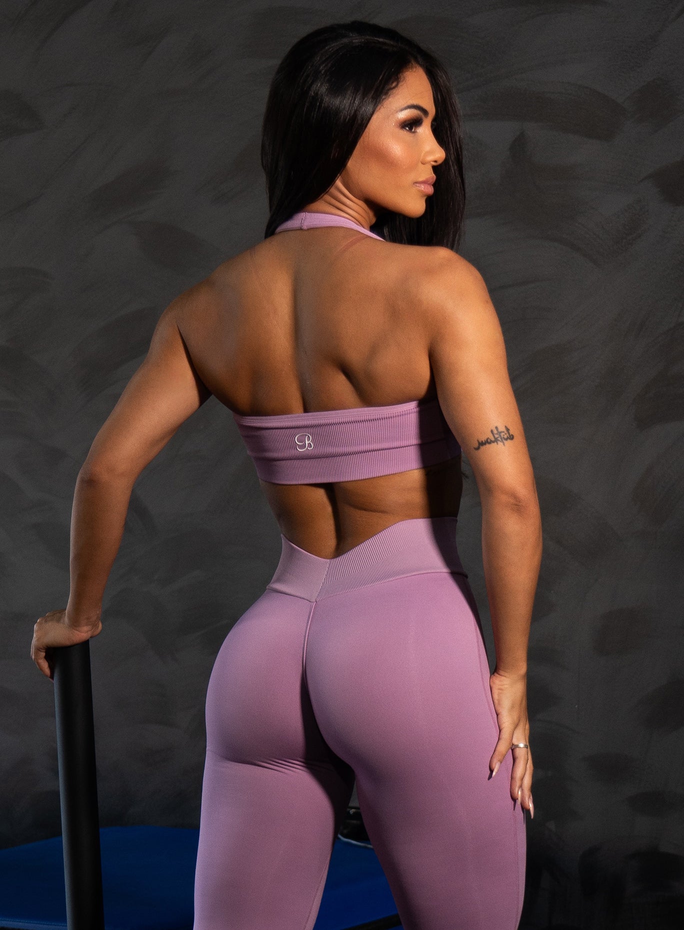 Smokey Grape Rib Backless Bra in seamless ribbed fabric with an open back for a sculpted gym look.
