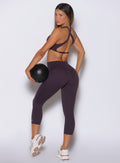 Black Orchid capris from the back, featuring a sleek finish for an athletic, toned look