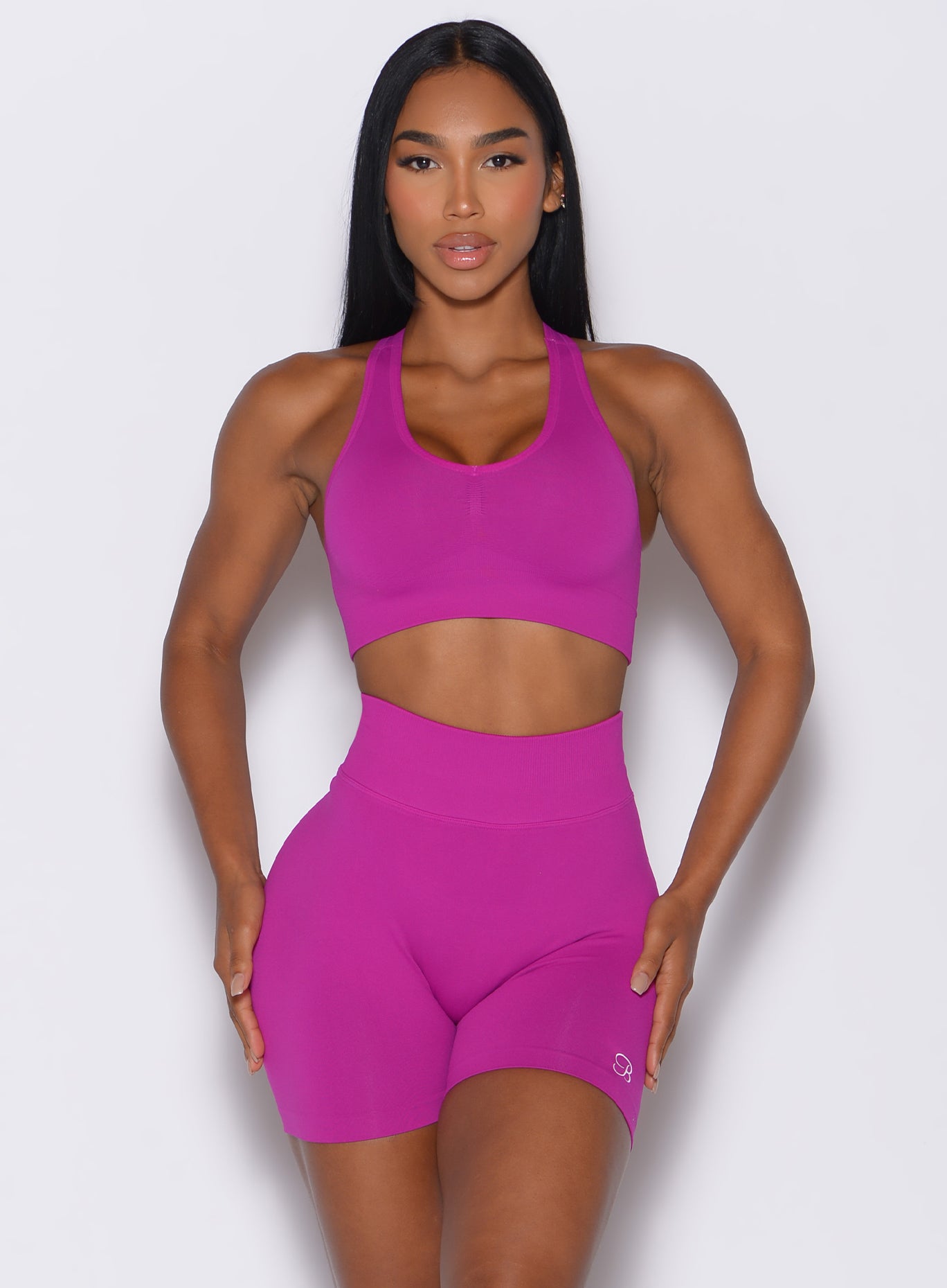 front profile picture of a model wearing our smooth seamless bra in berry color along with the matching shorts