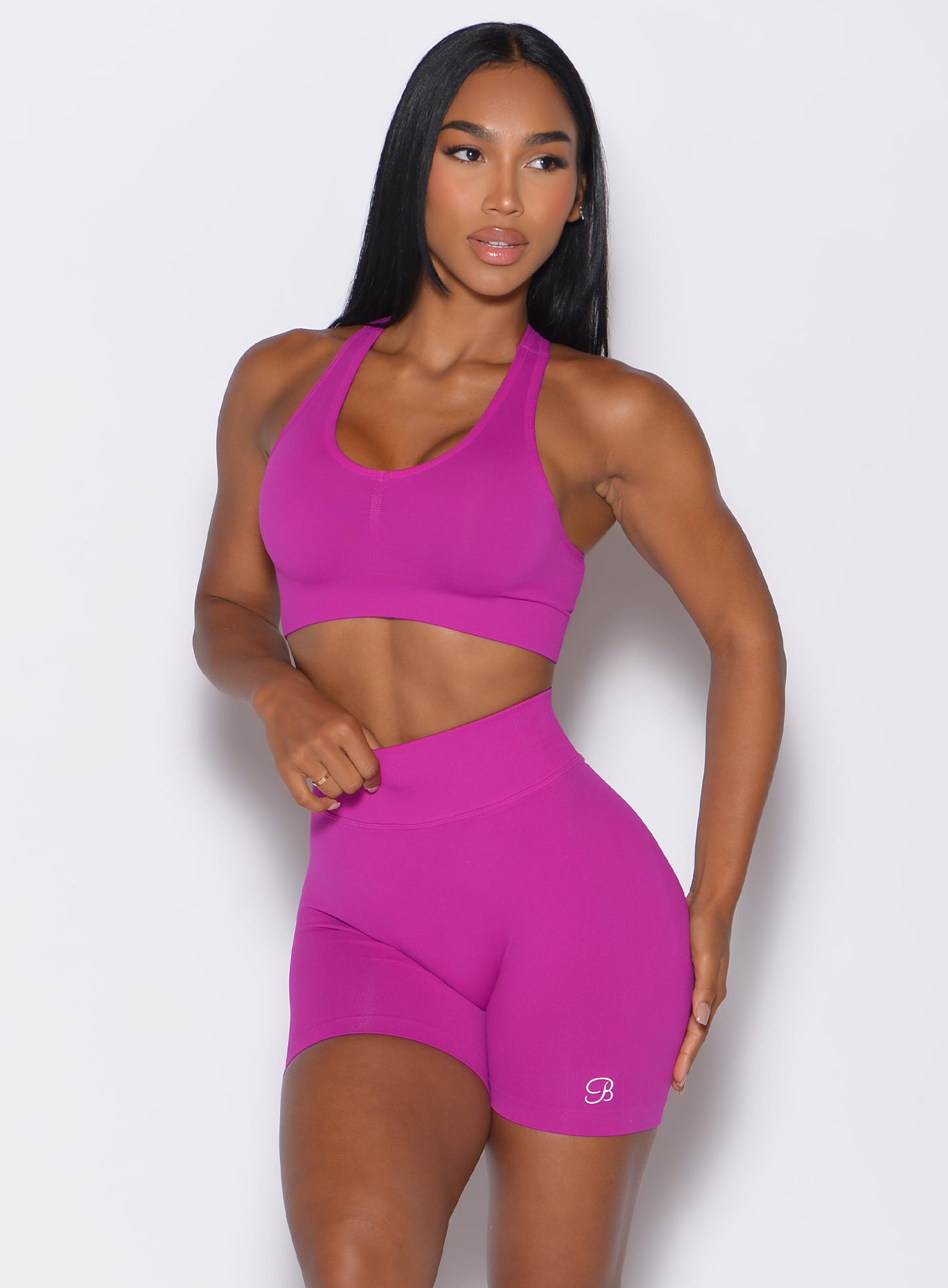 front profile view of a model wearing our smooth seamless bra in berry color along with the matching shorts