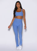 front profile view of a model wearing the Snape Flare Leggings in boss blue color
