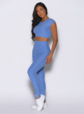 front left side profile view of a model wearing the Snape Flare Leggings in boss blue color