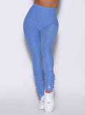 close up front view of a model wearing the Snape Flare Leggings in boss blue color