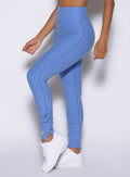 close up left side view of a model wearing the Snape Flare Leggings in boss blue color