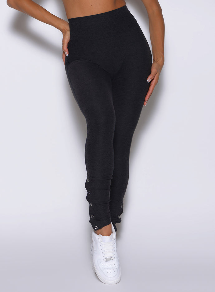 close up front view of a model wearing the Snape Flare Leggings in Heathered Black color