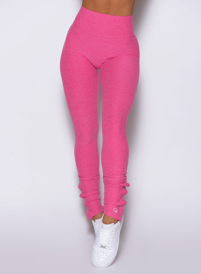 close up front view of a model wearing the Snape Flare Leggings in pink glo color