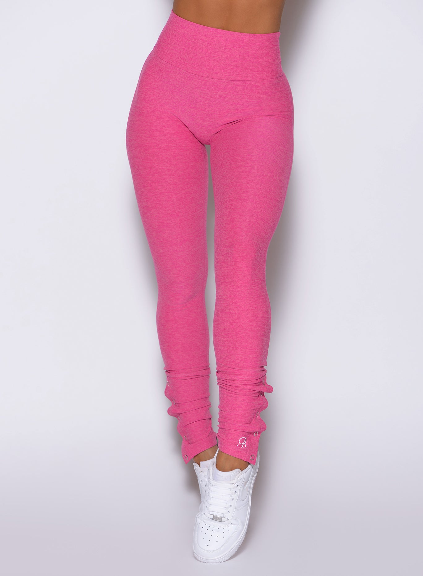 close up front view of a model wearing the Snape Flare Leggings in pink glo color