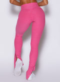 close up back side view of a model wearing the Snape Flare Leggings in pink glo color