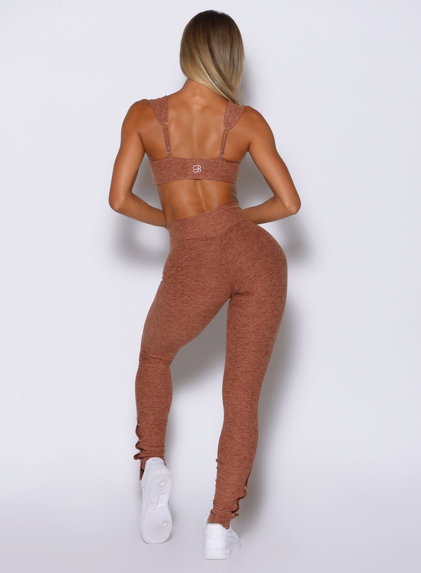 back profile view of a model wearing the Snape Flare Leggings in spiced chai color