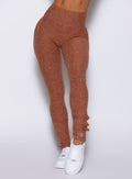 close up front view of a model wearing the Snape Flare Leggings in spiced chai color