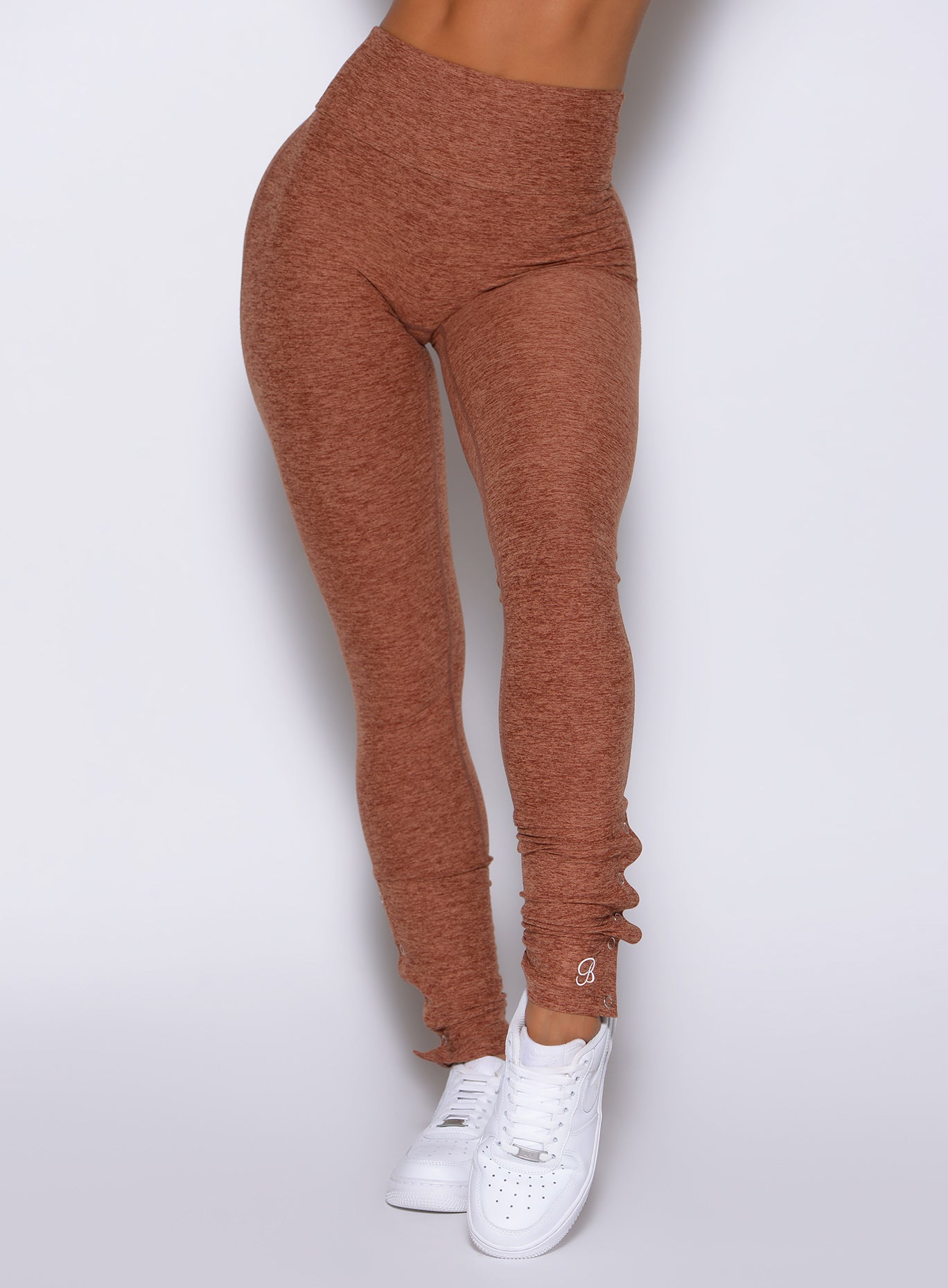 close up front view of a model wearing the Snape Flare Leggings in spiced chai color