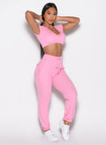 front right side profile view of a model wearing the Snap Rib Joggers in Pink Cupcake color