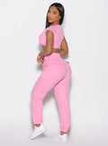 back left side profile view of a model looking over her shoulder wearing the Snap Rib Joggers in Pink Cupcake color