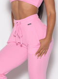 close up left profile shot of a model wearing the Snap Rib Joggers in Pink Cupcake color