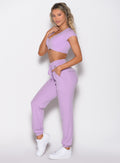 left side profile view of a model wearing the Snap Rib Joggers in Spring Fairy color paired with the matching top