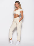 front left side profile view of a model wearing the Snap Rib Joggers in Vanilla Cream color