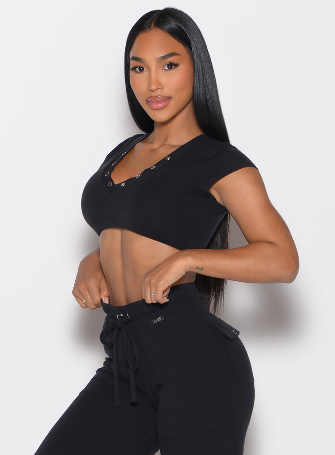 front left side profile view of a model wearing the Snap Top in black color