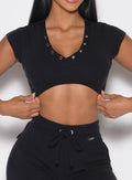 close up front profile view of a model wearing the Snap Top in black color