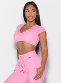 front left side profile view of a model looking to the left side wearing the Snap Top in Pink Cupcake color