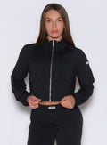 front view of a model wearing the Society Bomber Jacket in black color paired with the matching joggers