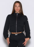 front view of a model wearing the Society Bomber Jacket in black color