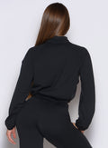 back side view of a model wearing the Society Bomber Jacket in black color