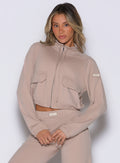 front view of a model wearing the Society Bomber Jacket in camel color