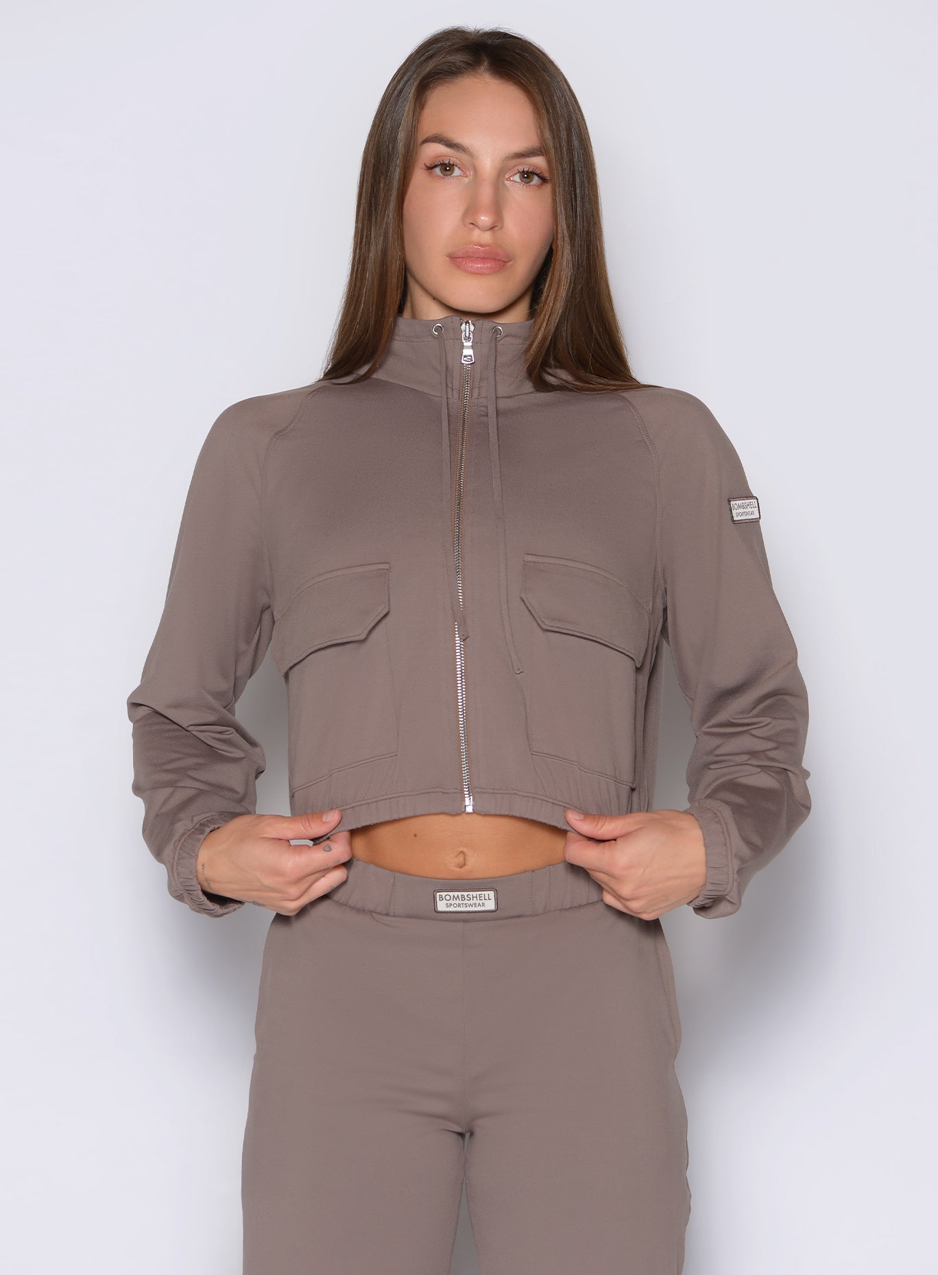 frontal shot of a model wearing the society bomber jacket in espresso color