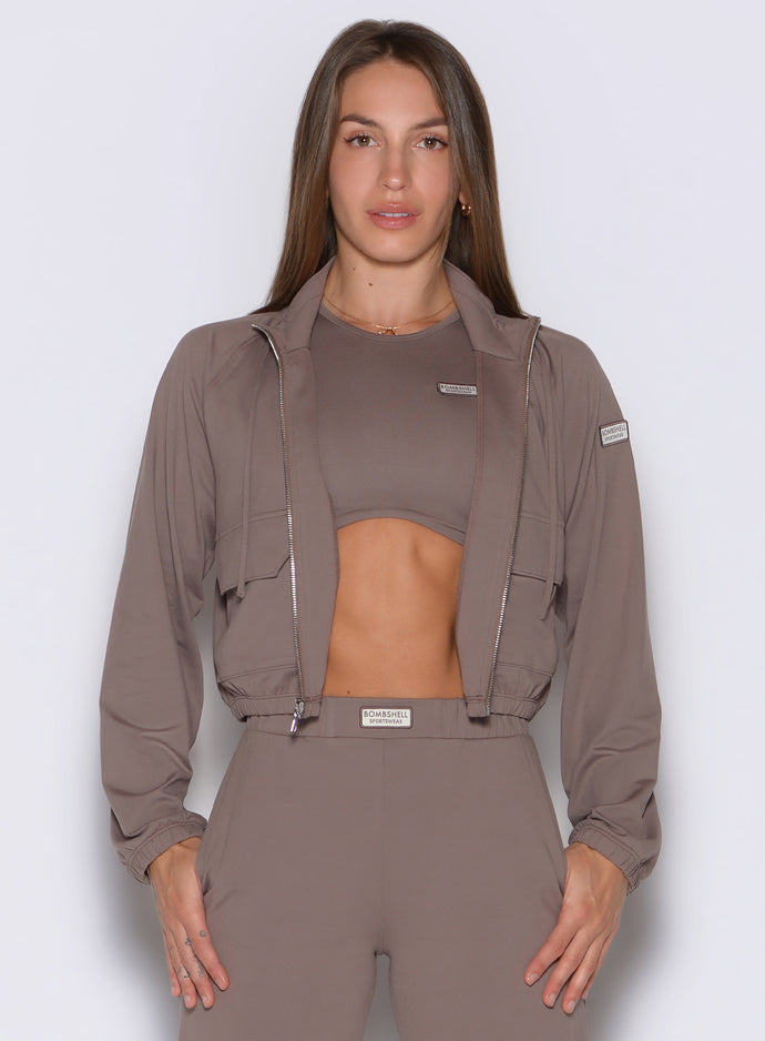 frontal view of a model wearing the Society Bomber Jacket in espresso color paired with the matching tank