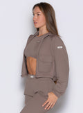 left side profile view of a model wearing the Society Bomber Jacket in espresso color