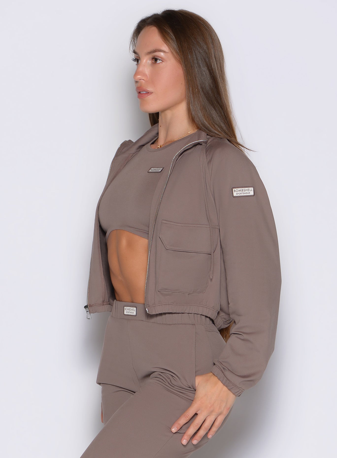 left side profile view of a model wearing the Society Bomber Jacket in espresso color