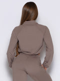 back side view of a model wearing the Society Bomber Jacket in espresso color