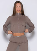 front view of a model wearing the Society Bomber Jacket in espresso color paired with the matching joggers