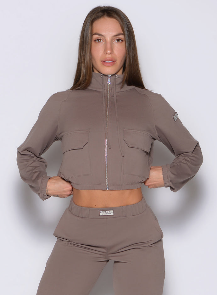 front view of a model wearing the Society Bomber Jacket in espresso color paired with the matching joggers