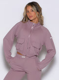 front view of a model wearing the Society Bomber Jacket in light mauve color