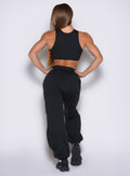 back side view of a model wearing the Society Joggers in black color