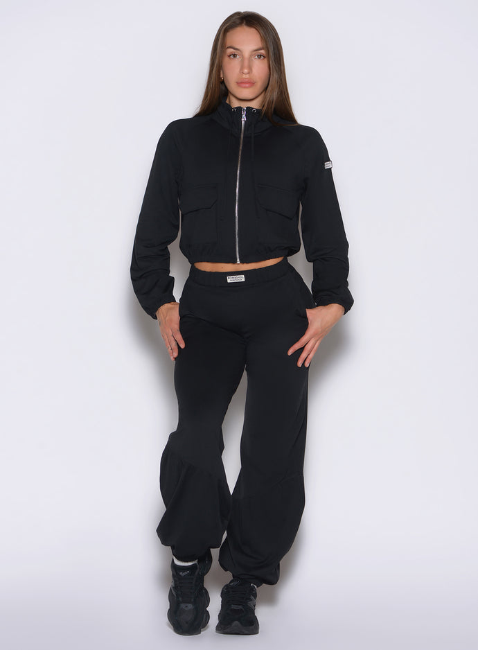 front view of a model wearing the Society Joggers in black color paired with the matching jacket