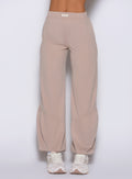 close up front view of a model wearing the Society Joggers in Camel color