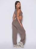 right side profile view of a model looking over her shoulder wearing the Society Joggers in Espresso color