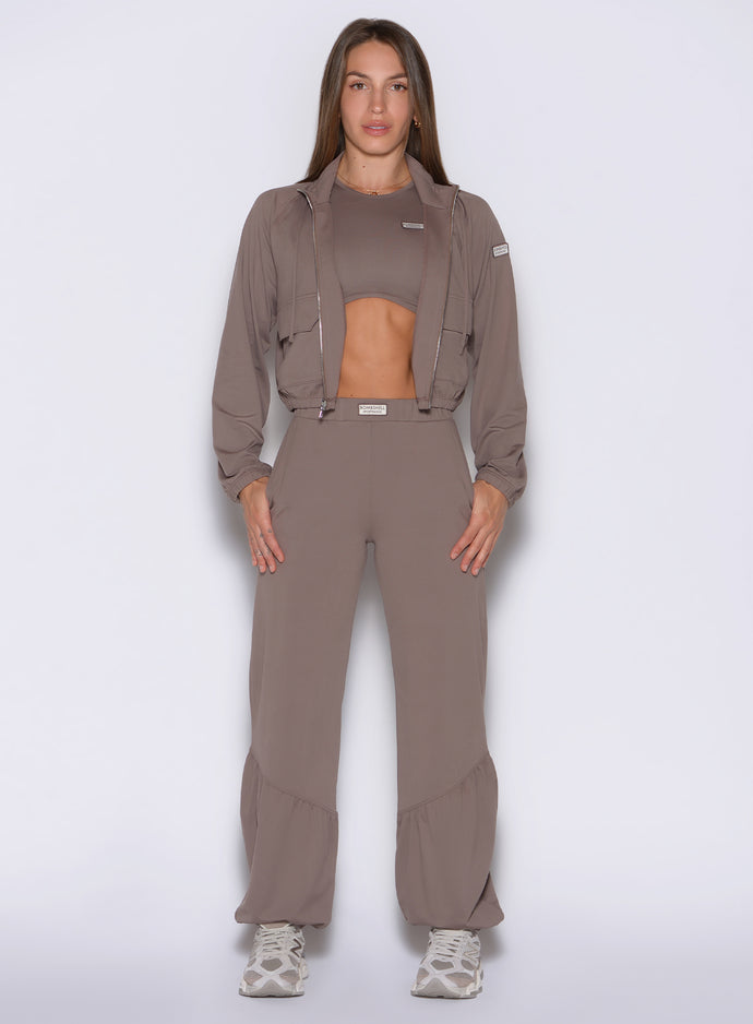 front profile view of a model wearing the Society Joggers in Espresso color paired with the matching tank and jacket