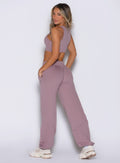 back left side view of a model looking over her shoulder wearing the Society Joggers in light mauve color