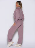 left side profile view of a model wearing the Society Joggers in light mauve color