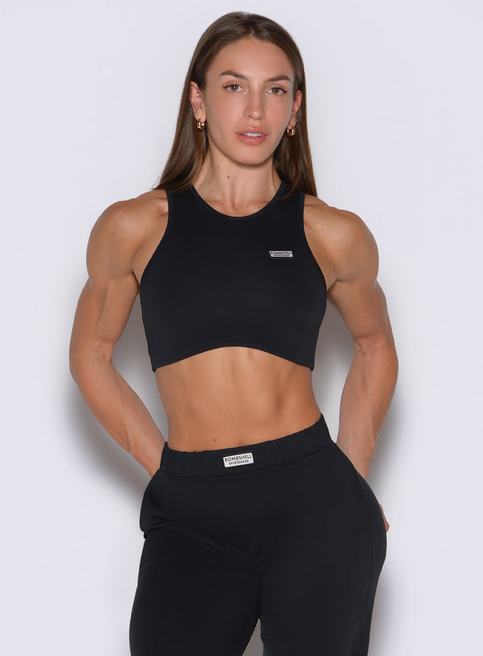 front profile view of a model wearing the Society Tank in black color